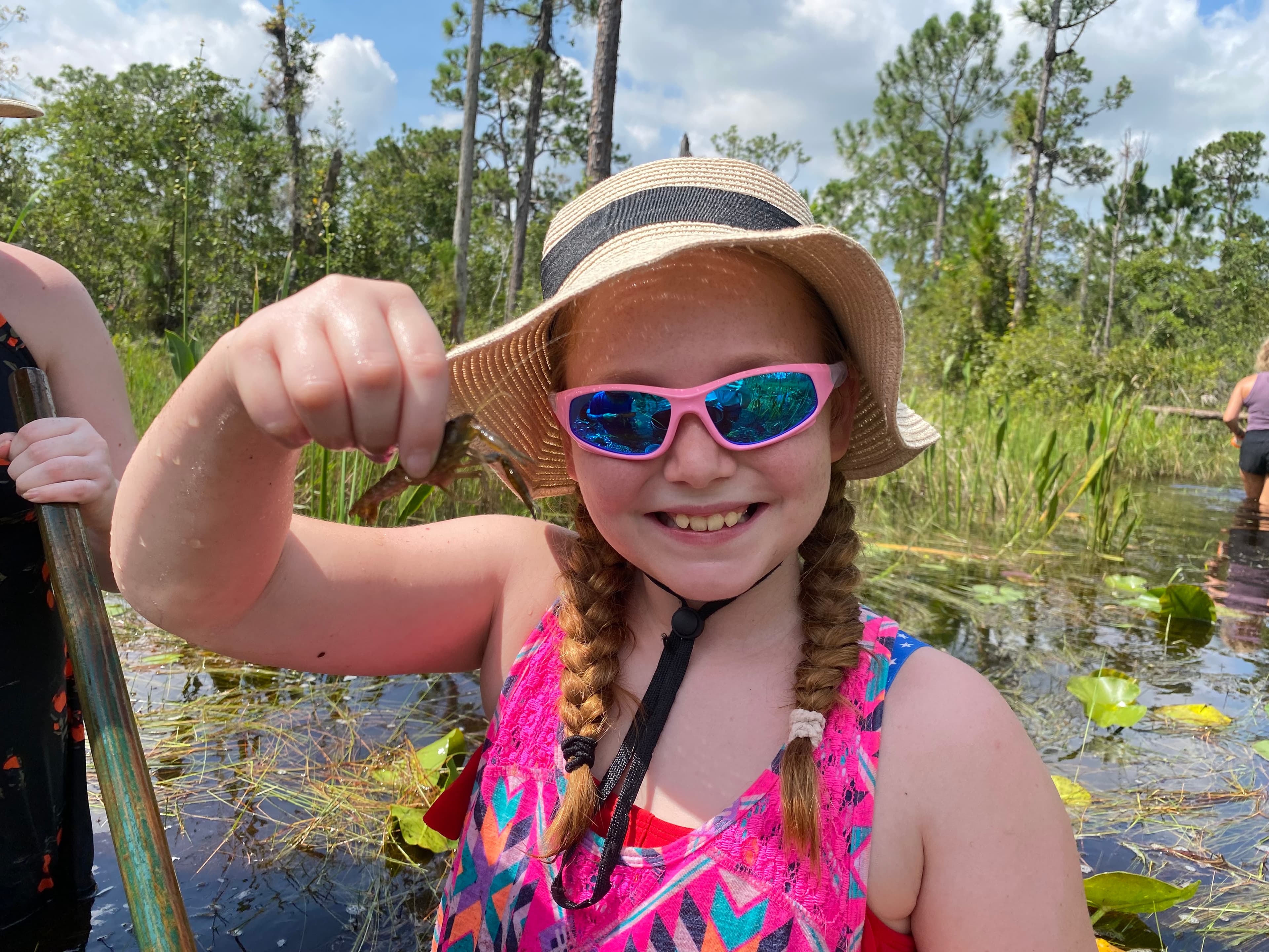 Girl holding a small fish