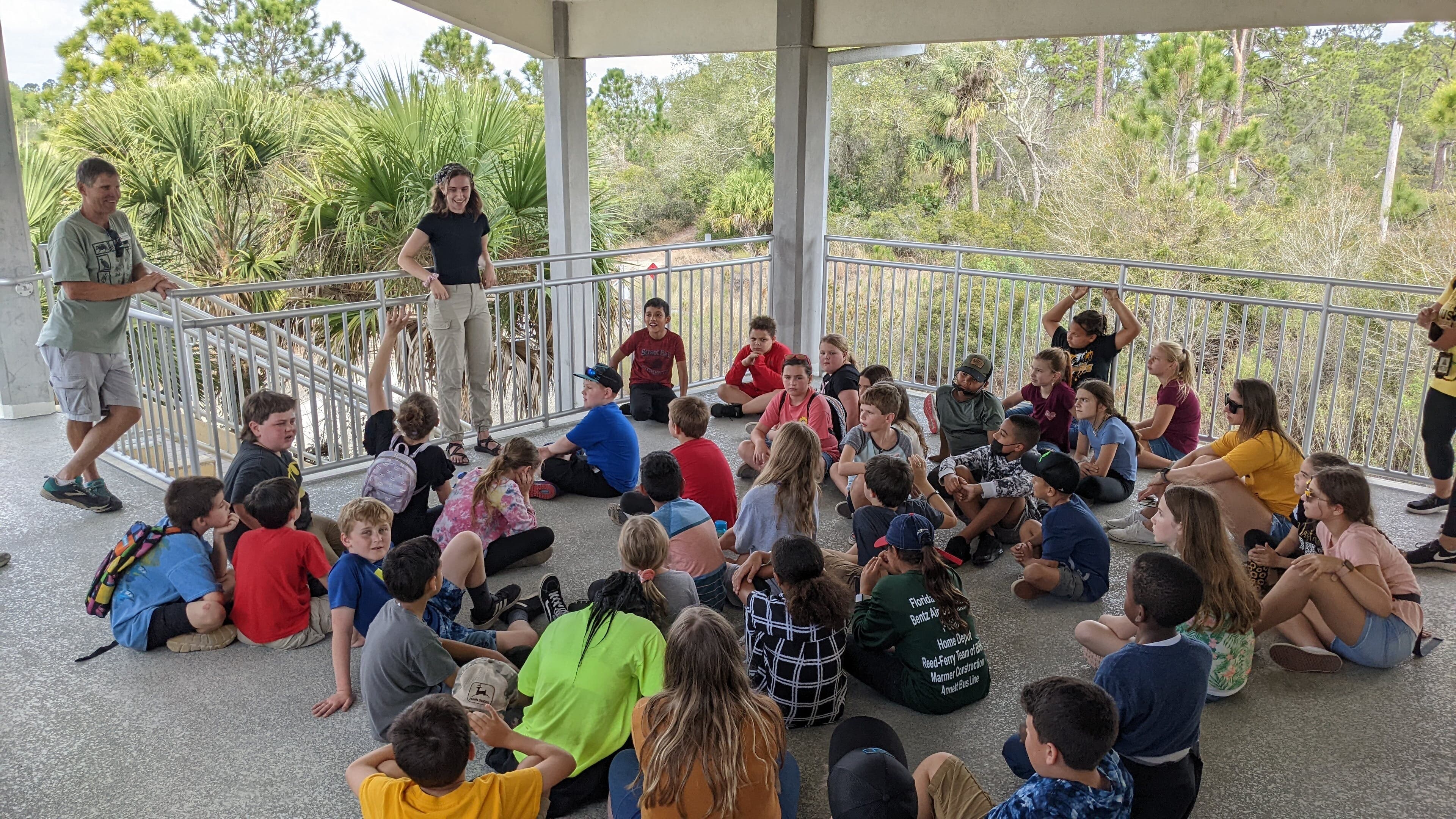 Katie Caldwell and volunteer Bob Wohlwend with a class on the Lodge overlook.